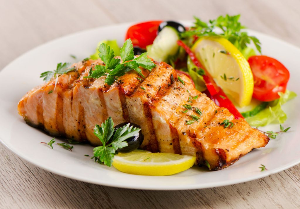 salmon fillets with lemon, tomato, and olive