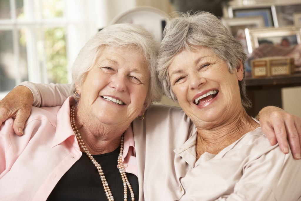two senior women socializing at home